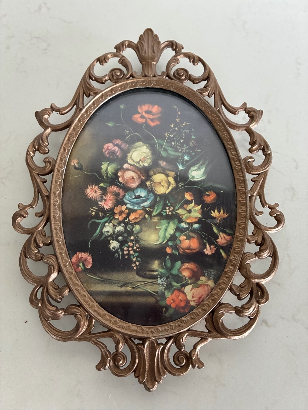 Vintage Italian ornate cast-metal oval wall hanging featuring floral still-life